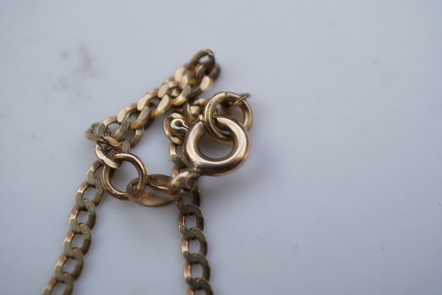 Two gold bracelets and a gold necklace